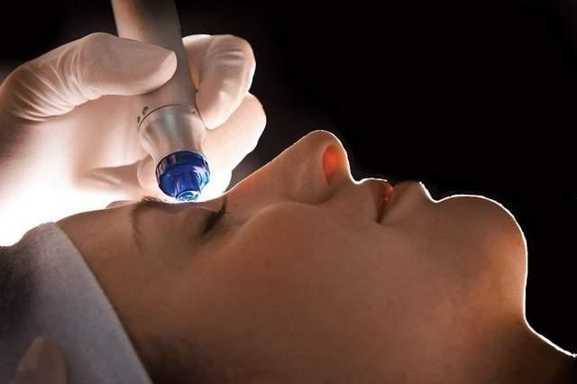 Young woman getting skincare treatment on face 