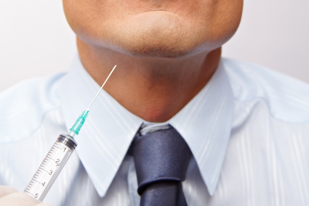Close up of man receiving a kybella injection in the chin