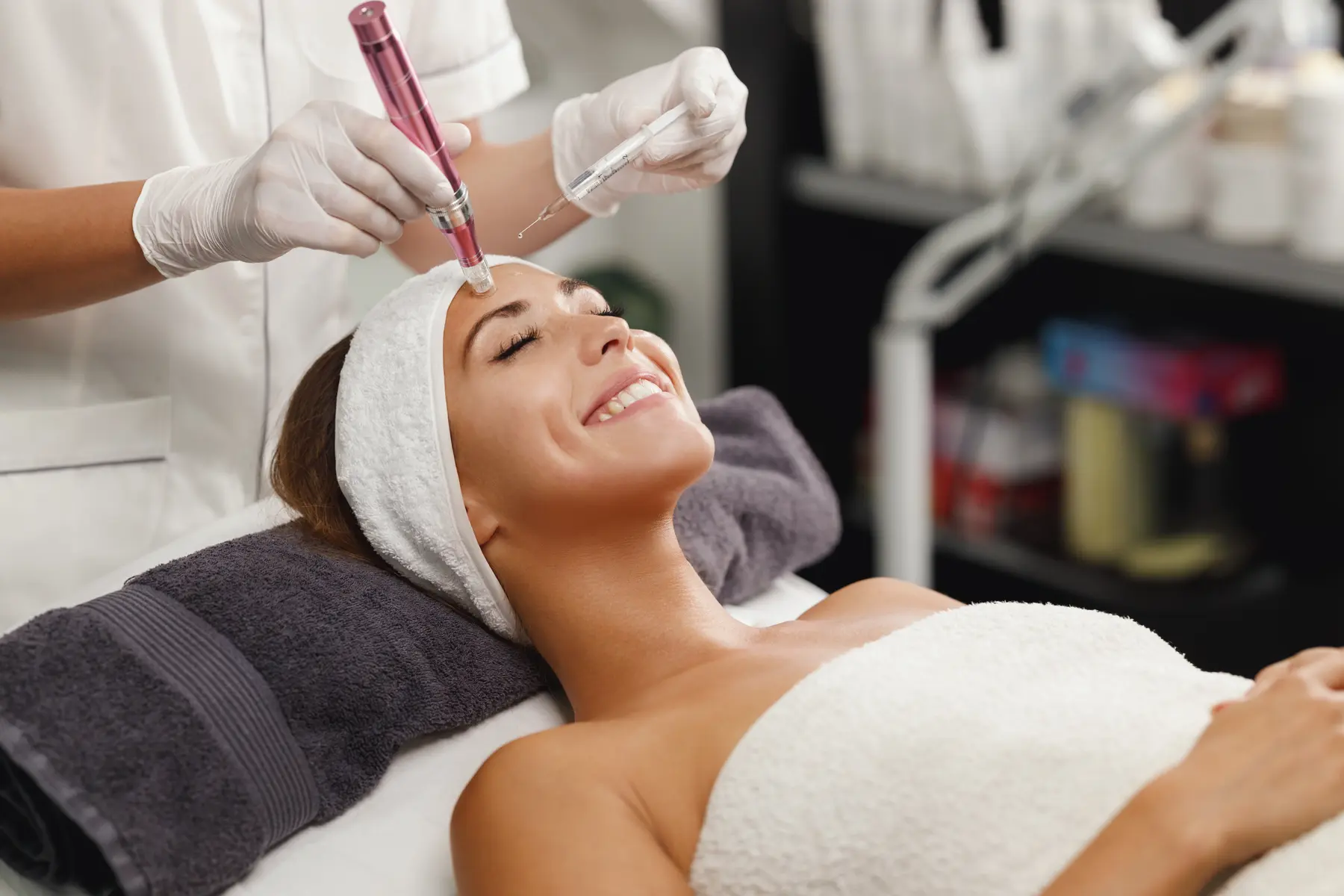 Woman receiving microneedling treatment in spa setting
